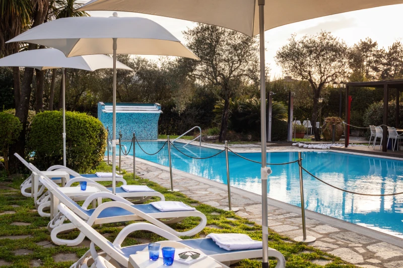 Poolside sunbathing area with loungers and umbrellas for wellness moments in Liguria - Sarzana Park Hotel, BZAR hotels in Liguria